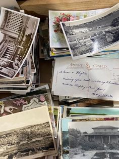 many old postcards are piled on top of each other