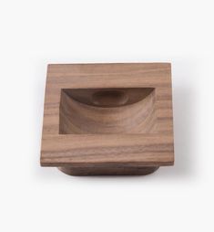 a square wooden object with a hole in the center