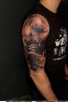 a man with a black and grey tattoo on his arm