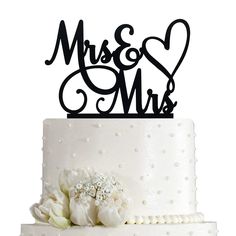 a wedding cake topper with the word mrs and mr written in cursive font