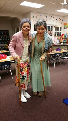 two women standing next to each other in a classroom