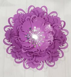 an overhead view of a purple paper flower