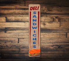 a sandwich sign hanging on the side of a wooden wall next to a wood floor