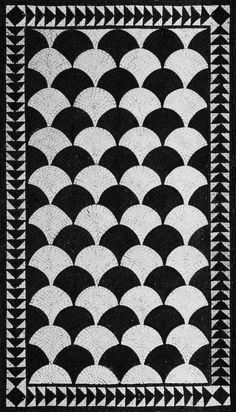 a black and white quilt with an art deco design on it's border,