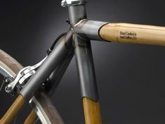 a close up view of the front end of a bike with wooden handlebars