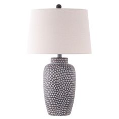 a table lamp with a white shade on it