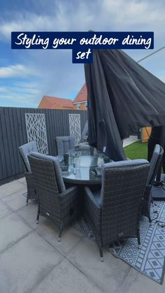 an outdoor dining set with umbrella and chairs