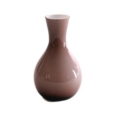 a brown vase sitting on top of a white table