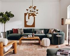 a living room filled with furniture and a chandelier hanging over the top of it