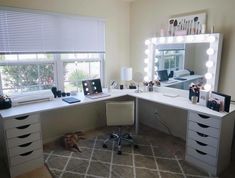 a white desk topped with drawers under a mirror next to a window covered in lights