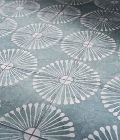 the floor is decorated with white flowers on blue ground cloths, which have been designed to look like fan - shaped petals