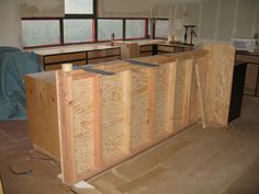 an unfinished kitchen counter is being built