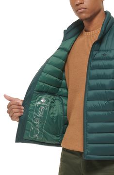 A quilted stand collar and lightweight fill insulate this heat-keeping puffer vest. 26 1/2" length (size Medium) Stand collar Front zip closure Front zip pockets Water resistant 100% nylon Machine wash, tumble dry Imported Functional Quilted Nylon Outerwear, Outdoor Nylon Quilted Jacket With Pockets, Green Nylon Puffer Jacket For Cold Weather, Outdoor Quilted Nylon Jacket With Pockets, Functional Down Quilted Jacket For Outdoor, Outdoor Functional Quilted Down Jacket, Weatherproof Nylon Puffer Jacket For Travel, Travel Weatherproof Nylon Puffer Jacket, Quilted Nylon Puffer Jacket For Travel