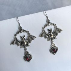 These large gothic vampire inspired earrings are made with antiqued silver plated bats, filigrees and stainless steel earring hooks,  accented with sparkling glass crystals in DARK RUBY RED. Earrings measure 3 1/2" tall and are 1 7/8" wide.Matching necklace is available in our shop. If you would like these in a different stone color, please send us a message. Punk Style Silver Jewelry For Costumes, Silver Punk Jewelry For Costume, Gothic Nickel Free Earrings For Halloween, Victorian Silver Costume Jewelry, Gothic Pierced Jewelry For Wedding, Silver Punk Costume Jewelry, Gothic Dangle Earrings For Wedding, Silver Vampire Style Costume Jewelry, Handmade Gothic Wedding Earrings