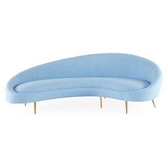 a blue curved couch sitting on top of a white floor