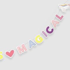 the word magic is hanging from a string with hearts and unicorns on it's sides