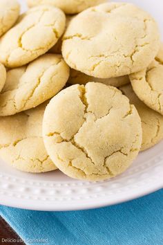 a white plate filled with cookies sitting on top of a blue cloth next to a wooden table