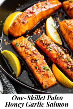 salmon and lemons cooking in a skillet with seasoning on the side for garnish