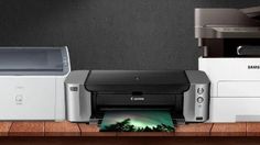 a printer and other office equipment on a desk with an image of the aurora in the background