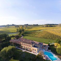 an aerial view of a large house with a swimming pool in the middle of it