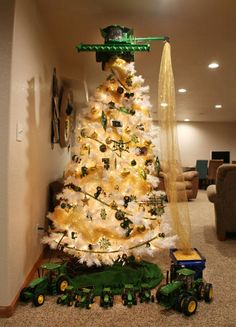 a white christmas tree decorated with green and gold ornaments