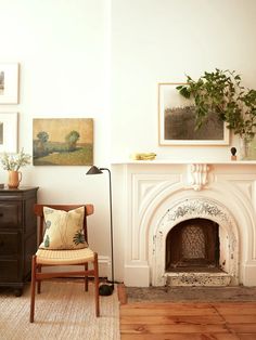 a living room filled with furniture and a fire place in front of a painting on the wall