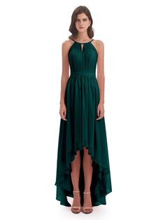 a woman is wearing a green dress with high low slits on the bottom and an asymmetrical neckline