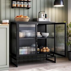 a kitchen with green walls and shelves filled with food