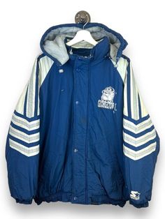 Vintage 90s Georgetown Hoyas NCAA Starter Full Zip Insulated Jacket Size Large MEASUREMENTS SIZE - Large PIT TO PIT - 27" LENGTH - 31" COLLAR TO CUFF - 29" Please note that due to the nature of pre-owned clothing; the size mentioned in the title may not be an accurate representation of the item's fit in accordance with modern sizing guides. Referring to the measurements will help to ensure that your garment will fit properly. CONDITION: 2/4 Wear / Marks Found around. Zipper Pull tab missing, sti Retro Hooded College Windbreaker, Vintage Windbreaker For Winter Streetwear, Vintage Winter Windbreaker For Streetwear, 90s Style Hooded Outerwear For College, Vintage Long Sleeve Windbreaker For Winter, Vintage Long Sleeve Winter Windbreaker, 90s Style Winter Windbreaker For College, 90s Style Winter Windbreaker, 90s Style Long Sleeve Outerwear For College