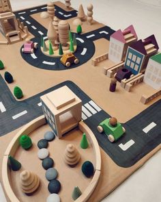 a wooden play area with cars and buildings