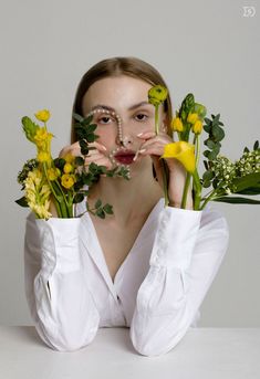 a woman holding flowers in front of her face