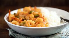 a white bowl filled with shrimp and rice