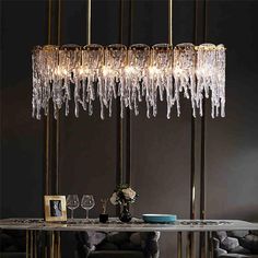 an elegant chandelier hanging over a dining room table