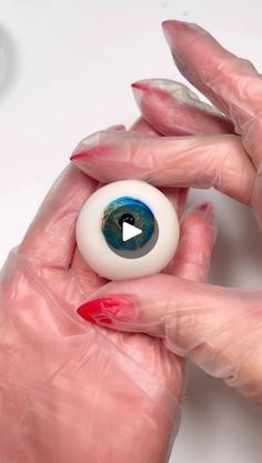 a woman holding an eyeball in her hands