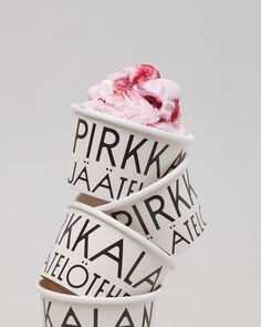 three ice cream cups stacked on top of each other with different types of toppings