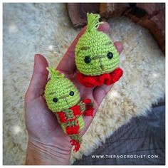 two small crocheted dolls in the palm of someone's hand