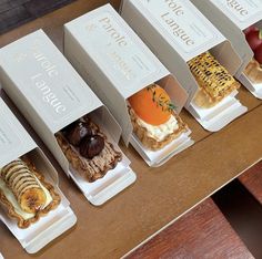 five different types of pastries in boxes on a table