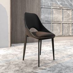 a black chair sitting on top of a carpet covered floor in front of a wall