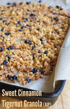 a close up of a tray of food on a table with text overlay that reads sweet cinnamon tigernut granola air