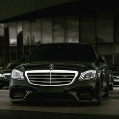 a black car parked in front of a building