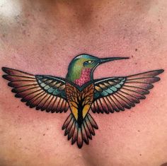 a colorful hummingbird tattoo on the chest