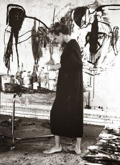 a woman standing in front of a painting with the words, the art of dressing