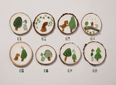 six pieces of wood with trees and animals on them, all cut into smaller slices