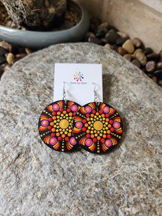 These unique wooden mandala earrings are a stunning piece of wearable art that will make a great addition to your accessory collection! Dress them up or wear them casually either way they are sure to suit every occasion. The wooden discs are hand painted dot by dot and sealed for shine and protection and they are light weight which makes them very comfortable to wear! The hand painted discs come on a shepherd hook style earrings The total drop of earring is approx 7cm with each disc measuring 5cm. If you love this design but would like it in a different colour please feel free to message me and I will be more than happy to chat with you about creating something for you. Note: *This is a loving handmade piece and is classed as costume jewellery, It should be handled with care and never subm Painted Discs, Dot By Dot, Mandala Earrings, Main Point, Shepherds Hook, Hand Painted Earrings, Painted Earrings, Make Color, Dots Art