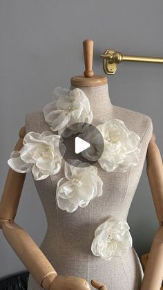 a mannequin with white flowers on it