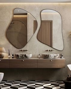 a bathroom with two sinks and mirrors on the wall