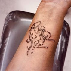 a woman's arm with a tattoo on it and the word yoga written in black ink