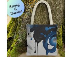 This abstract blue everyday bag, a creative gift for artists, doubles as a durable shopping tote--a versatile artistic carryall perfect for women, making it an ideal gift idea for a coworker seeking both style and functionality. 𝘿𝙀𝙏𝘼𝙄𝙇𝙎 (𝗦𝗽𝗹𝗮𝘀𝗵 𝗼𝗳 𝗕��𝗹𝘂𝗲 𝗧𝗼𝘁𝗲) ✦ Front and Back Printing ✦ Highly Durable ✦ Made with 100% polyester, a medium-weight fabric (6.49 oz/yd² (200 g/m ✦ Non-woven laminate inside ✦ Cotton handle ✦ Size tolerance 0.75" (1.9 cm) ✦ Boxed corners for more s Art Supply Bag, Idea For Art, Gift For Artist, Art Supplies Bag, Gift For Coworker, Carryall Tote, Custom Notebooks, Blue Tote, Art Supply