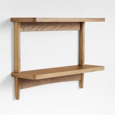 a wooden shelf mounted to the side of a wall with two shelves on each side