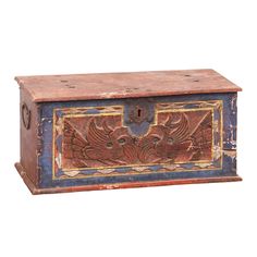 an old wooden box with decorative designs on it